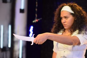 Charlotte Corday holds a knife.