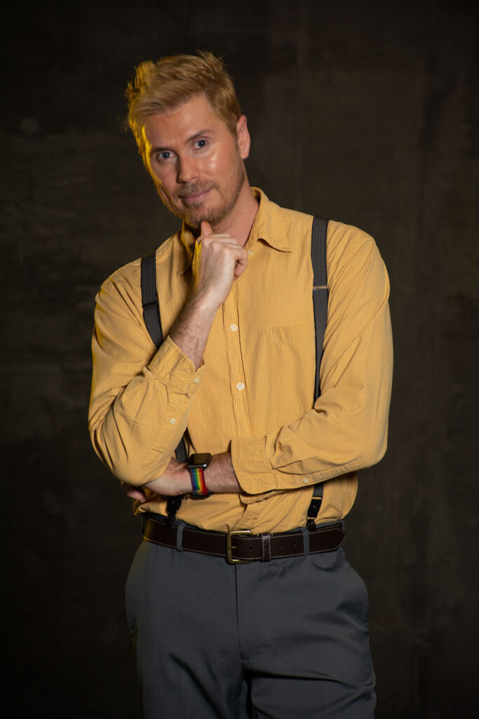 Man in a yellow button down and suspenders